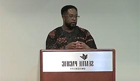 Jemar Tisby delivers a lecture in Upper Gwinn